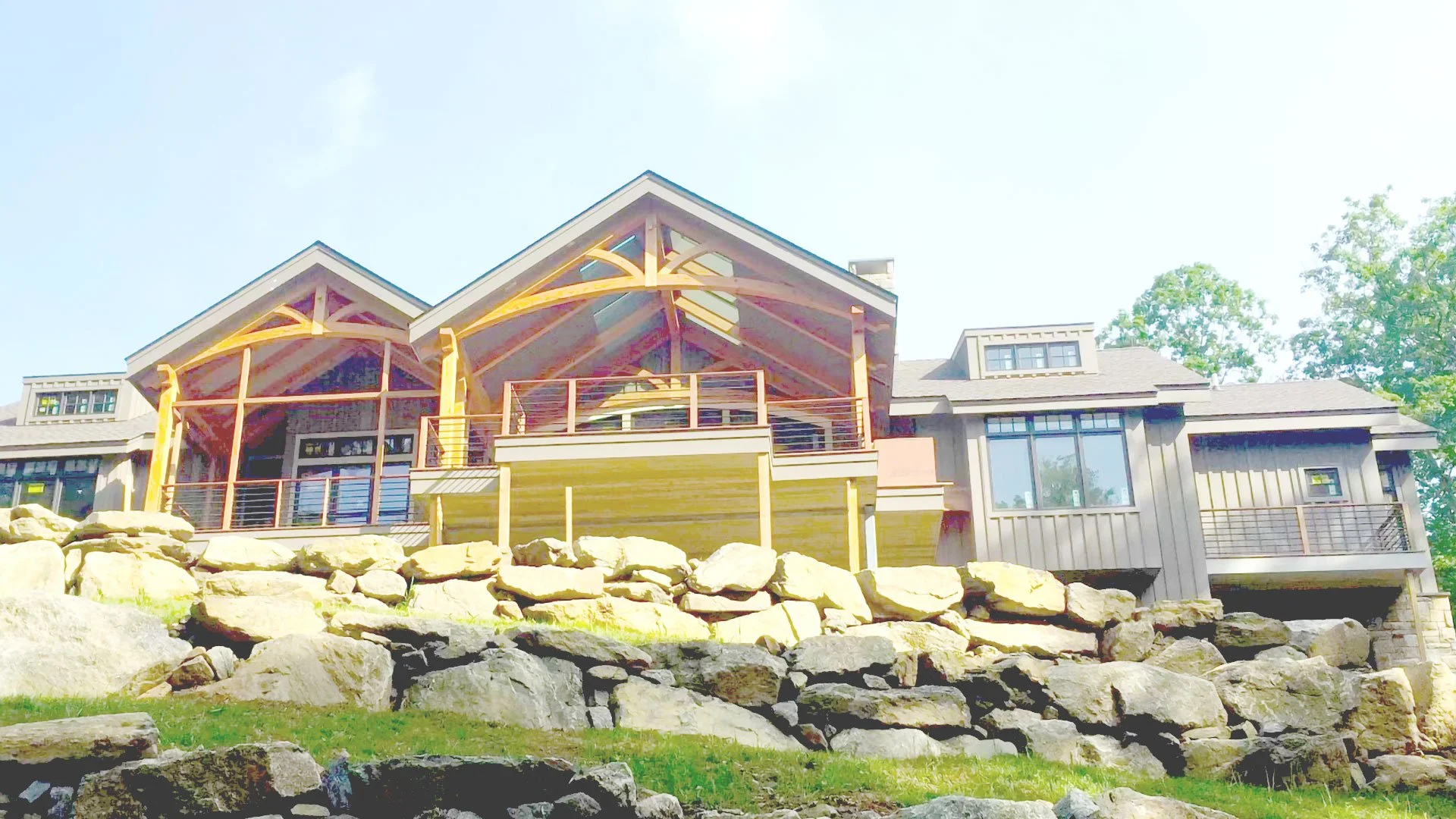 Timber-framed home exterior with stone retaining wall